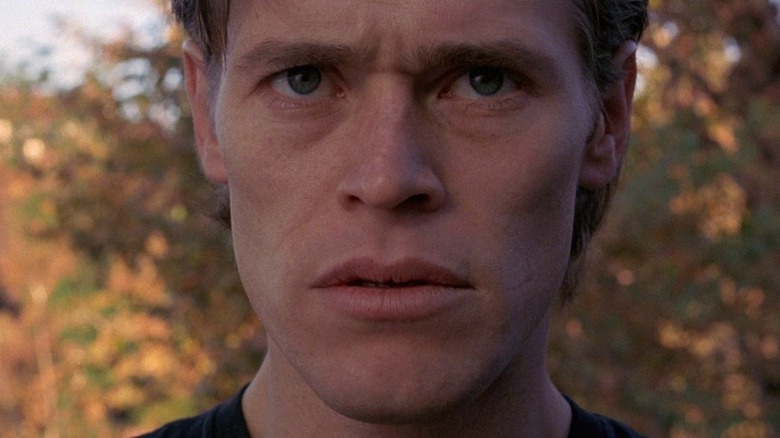 Willem Dafoe stares intently