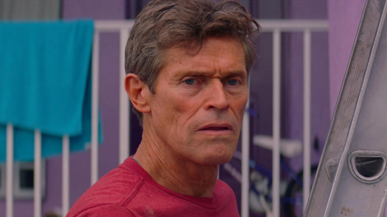 Willem Dafoe looks onward