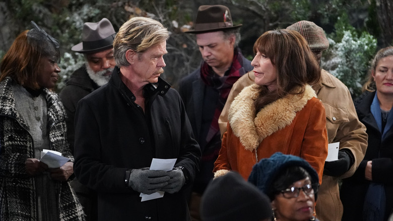 William H. Macy and Katey Sagal standing and talking to each other outside