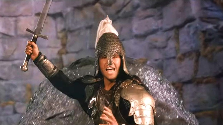 Val Kilmer holding up sword in "Willow"