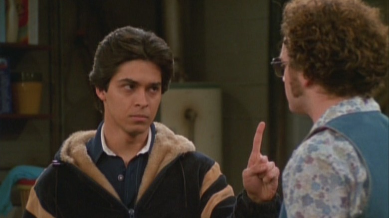 Fez holding his finger to Hyde