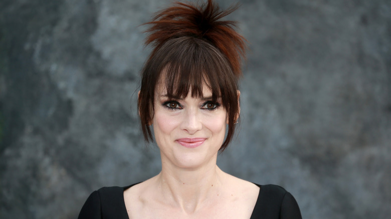 Winona Ryder smiling gray background