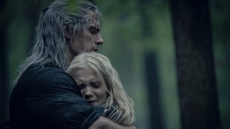 Geralt embracing Ciri in the woods