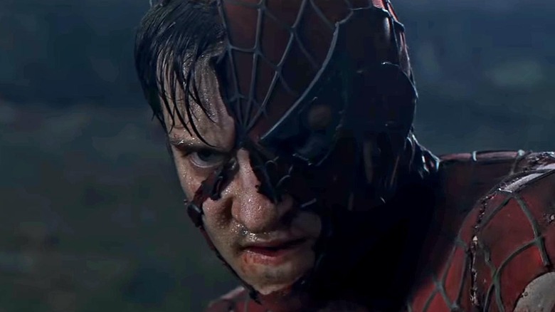 Peter Parker glaring through ripped Spider-Man mask