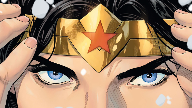 Wonder Woman adjusting her tiara