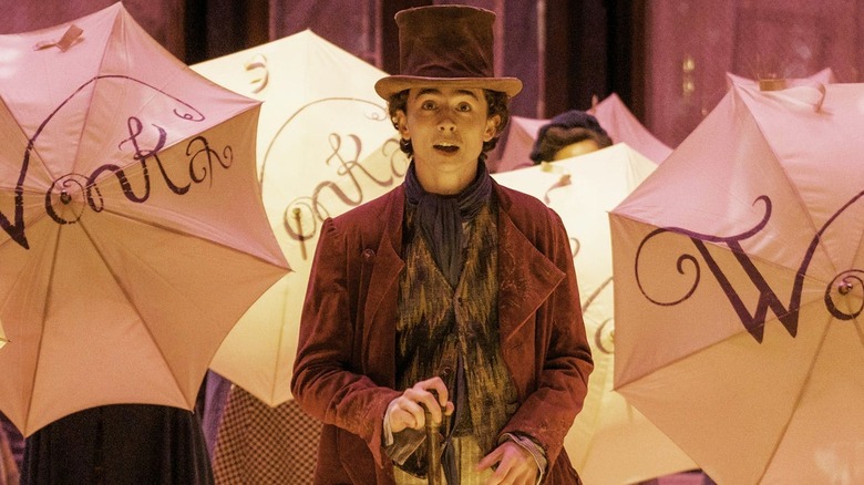 Wonka stands in front of umbrellas in "Wonka" (2023)