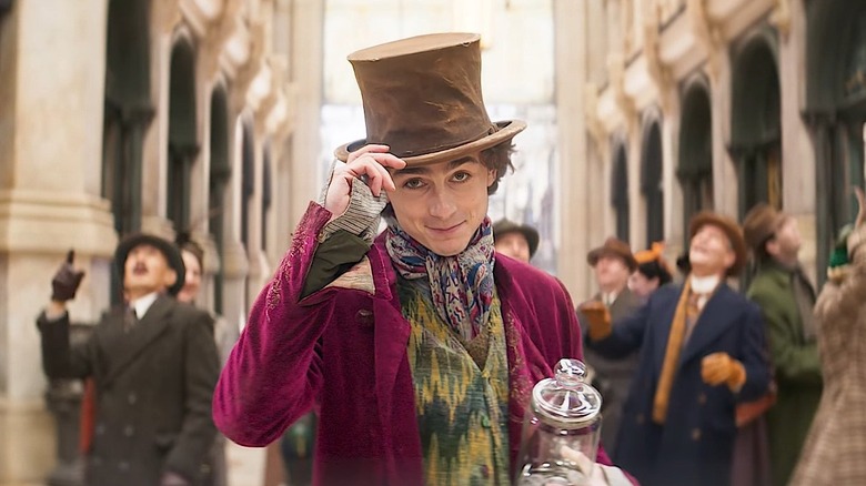 Wonka tips his hat and smiles in "Wonka" (2024)