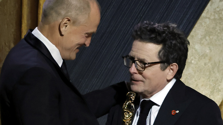 Woody Harrelson giving an award to Michael J. Fox