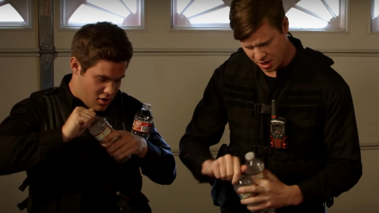 Adam and Ders opening water bottles