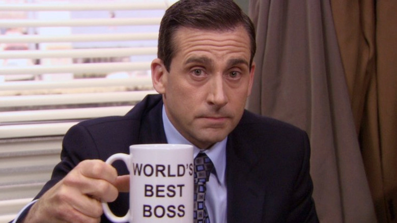 Michael holding World's Best Boss mug