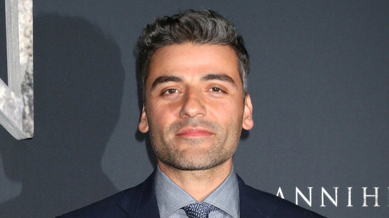 Oscar Isaac smiling and posing