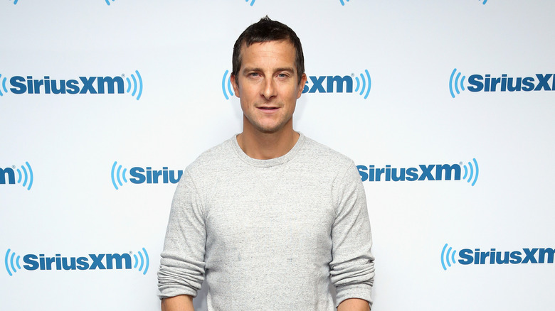 Bear Grylls poses at event 