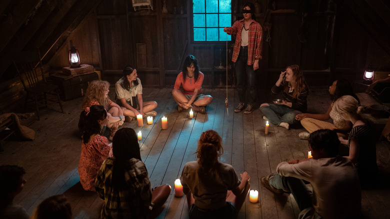 Girls gather in candlelit circle