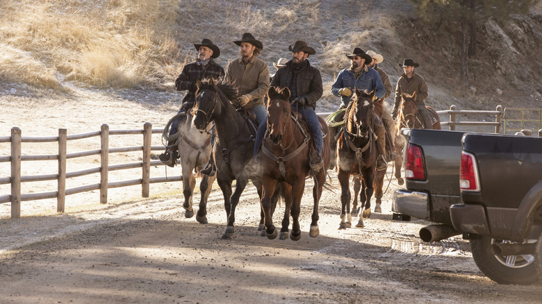 Duttons and ranch hands riding horseback