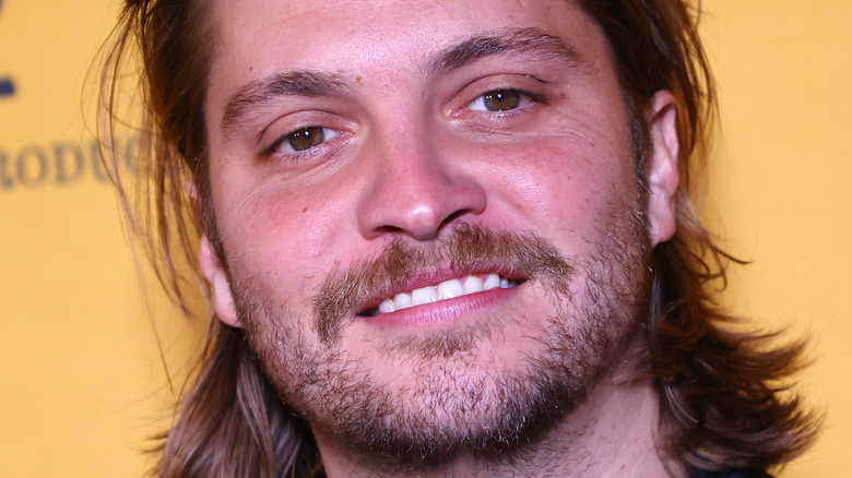 Luke Grimes smiling at event