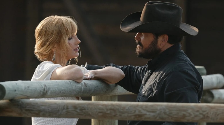 Beth and Rip talking over a fence on the ranch in Yellowstone finale