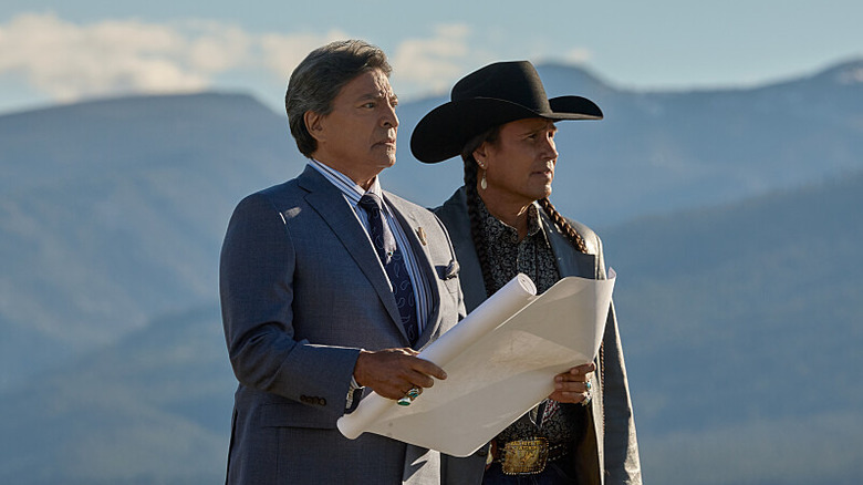 Mo and Thomas look out over the Dutton property with a map