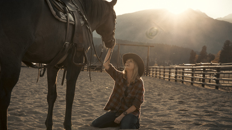 Beth smiling at a horse