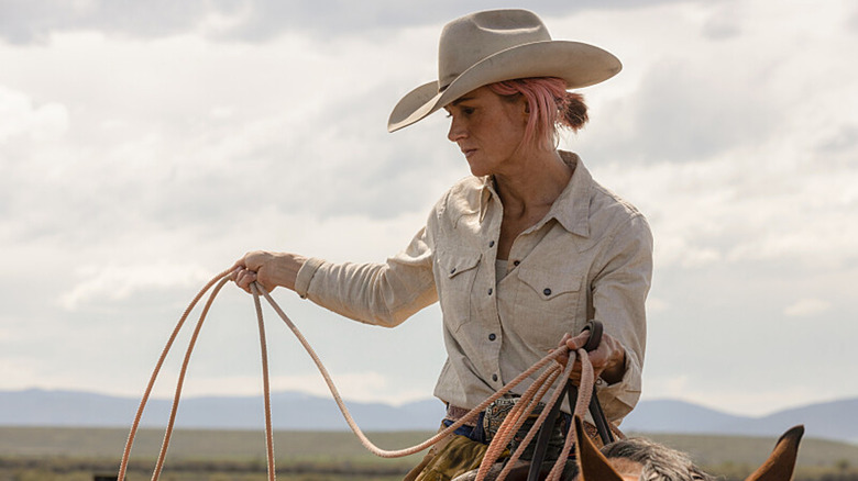 Teeter holding a lasso