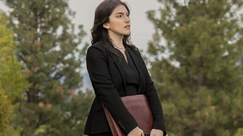 Clara holding briefcase