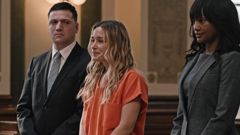 Piper Perabo standing between lawyers on Yellowstone