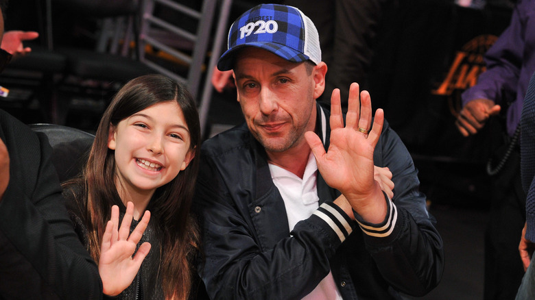 Adam and Sunny Sandler at a basketball game