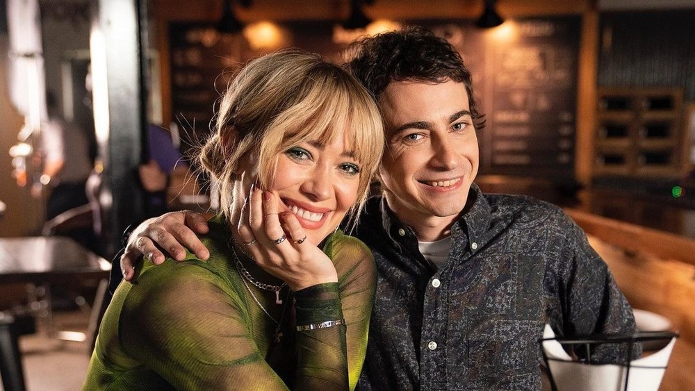 Hilary Duff and Adam Lamberg smiling in restaurant