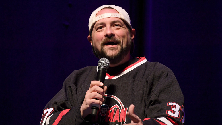 Kevin Smith holding a microphone