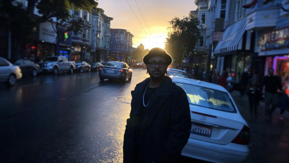 Craig Lamar Traylor standing in front of sunset in Brooklyn