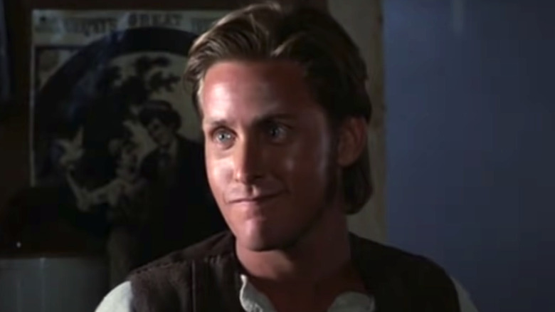 Billy the Kid smirking in a bar in Young Guns