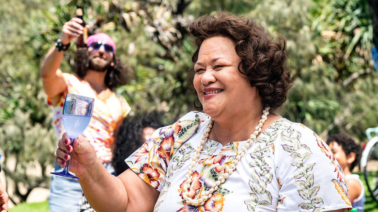 Ana Tuisila as Lia Maivia making a toast in Young Rock