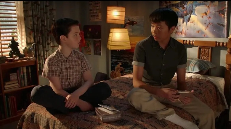 Sheldon and Tam sitting on bed