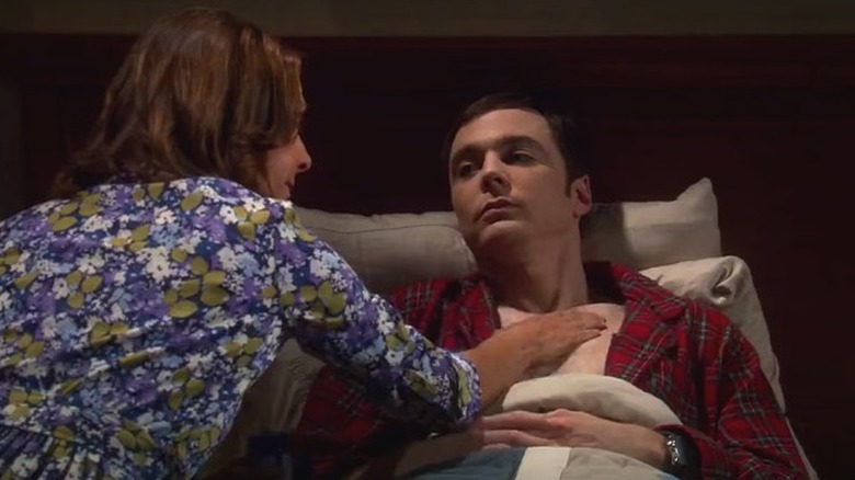 Older Mary tucking in Sheldon