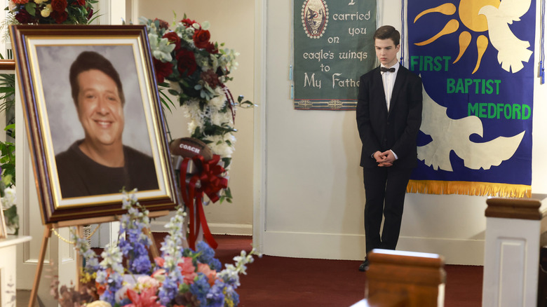 Sheldon standing at George's funeral