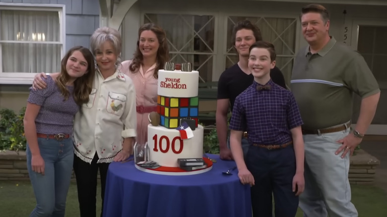 Young Sheldon cast with 100th episode cake