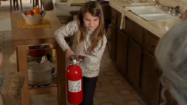 Missy holding fire extinguisher