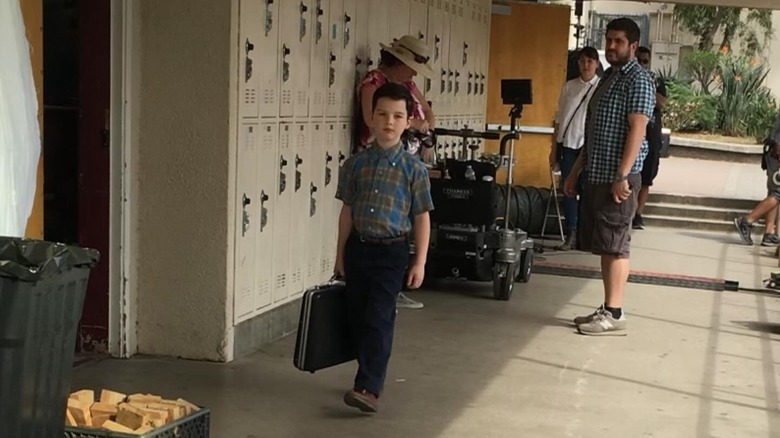 Young Sheldon holding briefcase