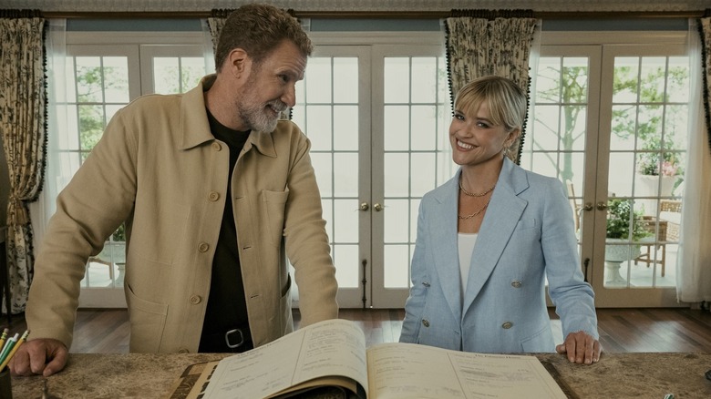 Jim and Margot smiling by reservation book