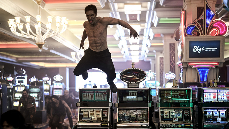 A zombie leaps over a slot machine