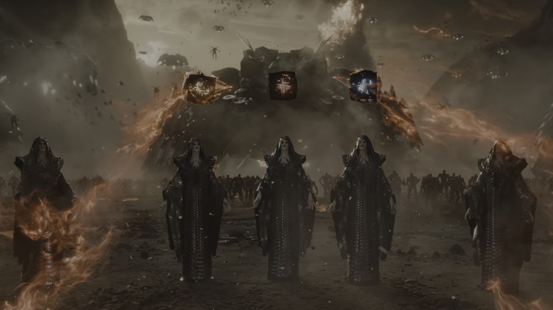 Apokalips priestesses stand beneath three motherboxes on a battlefield