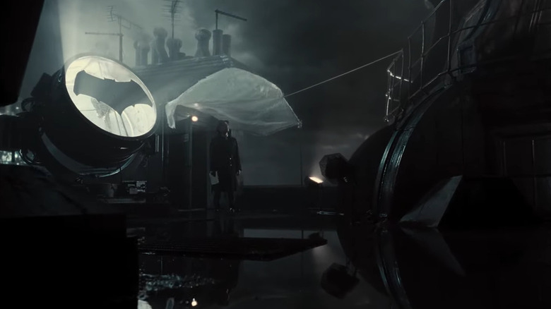 James Gordon stands next to the bat signal