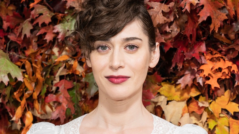 Lizzy Caplan smirking