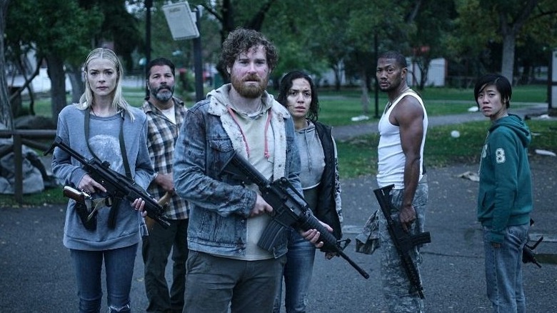 Survivors preparing to fight zombie horde